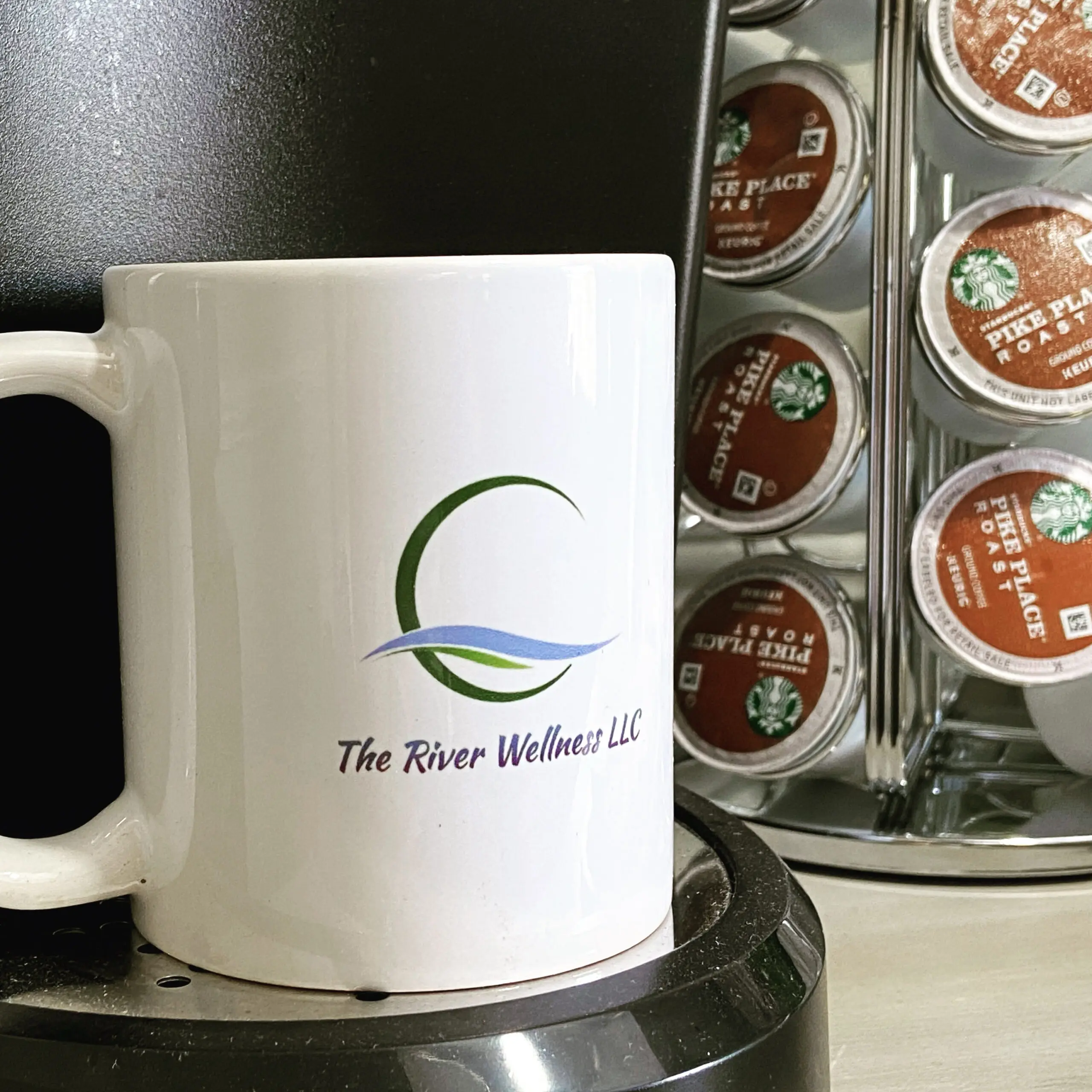 A coffee mug sitting on top of a coffee maker.