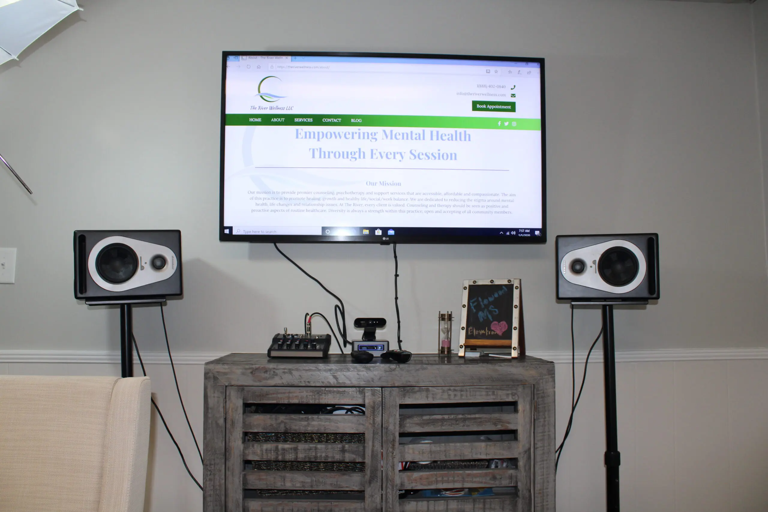 A tv and speakers on top of a table.