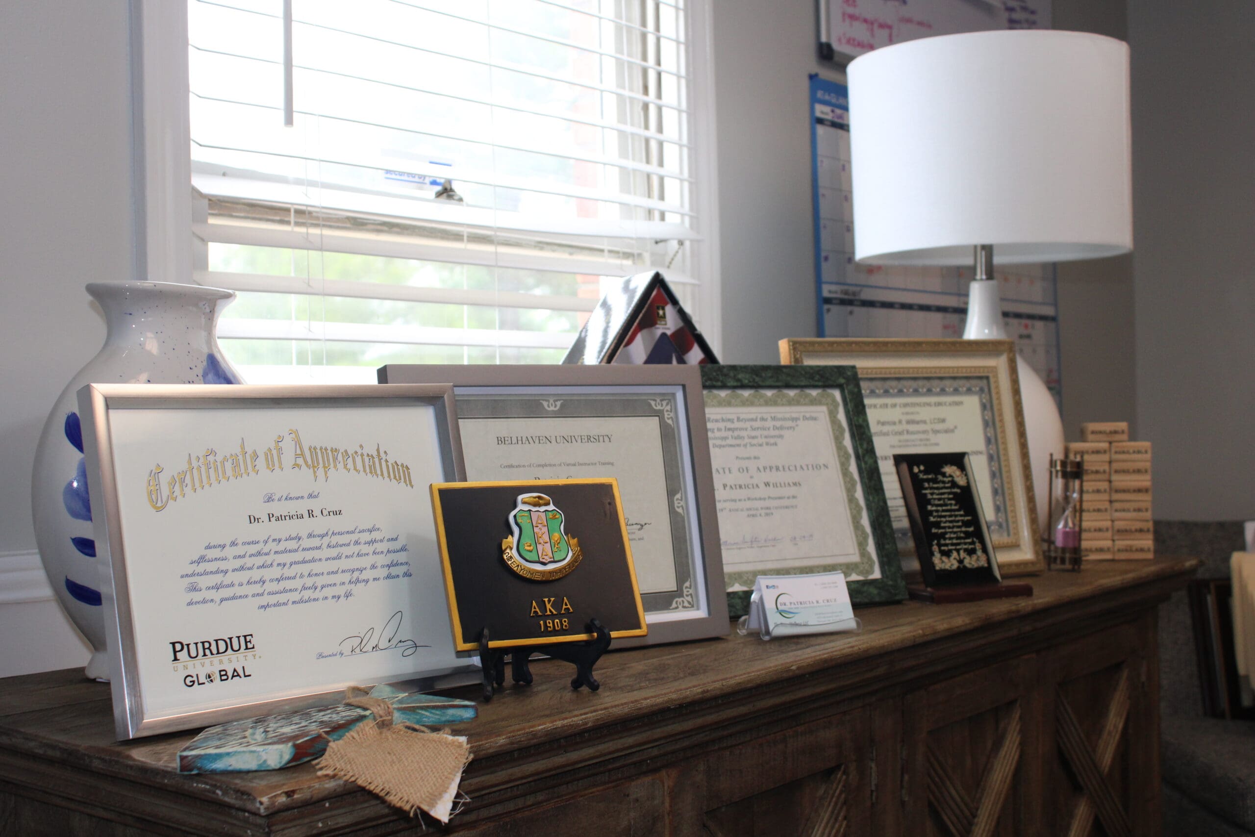 A table with several framed certificates and awards on it.