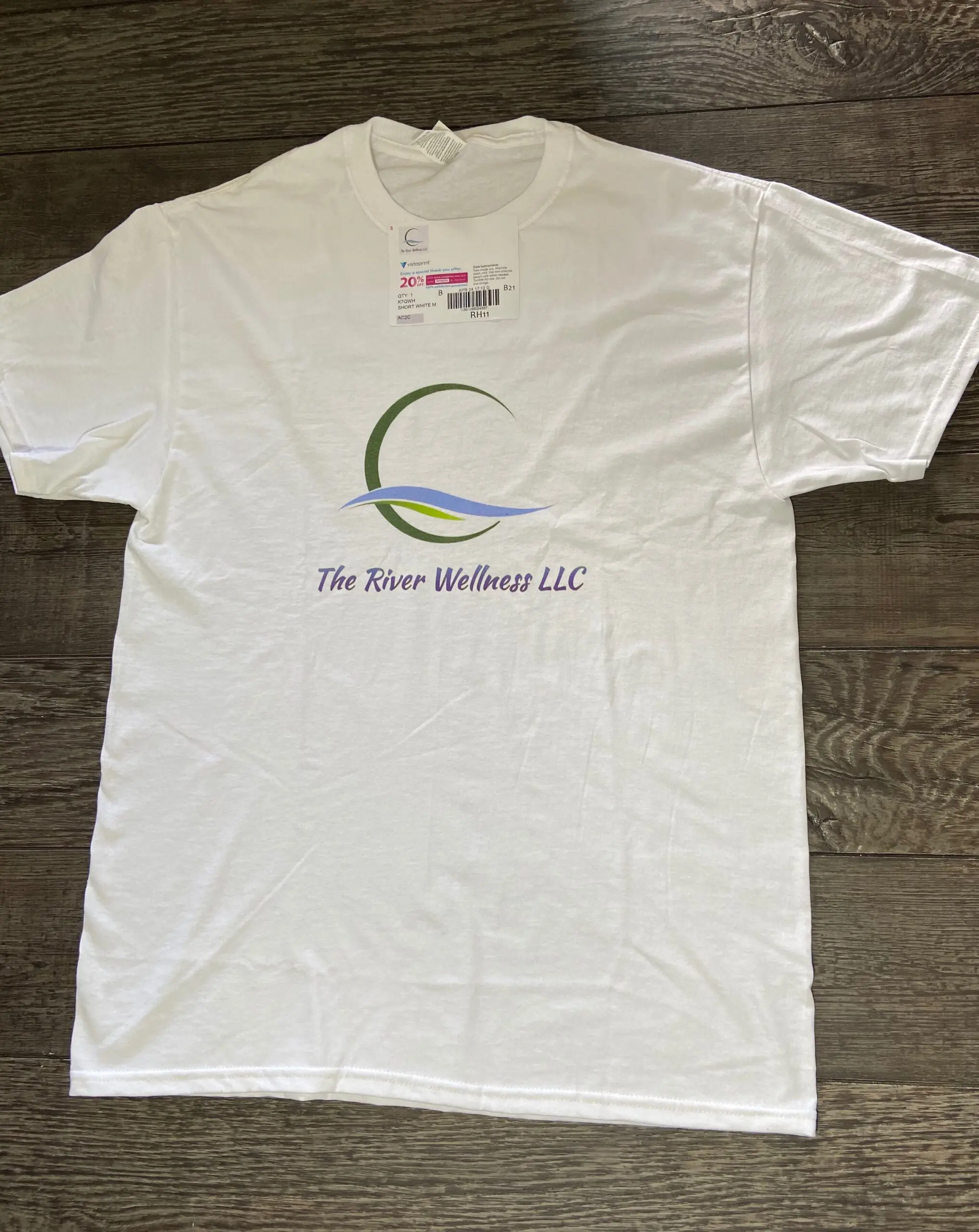 A white t-shirt with the logo of the river wellness llc.