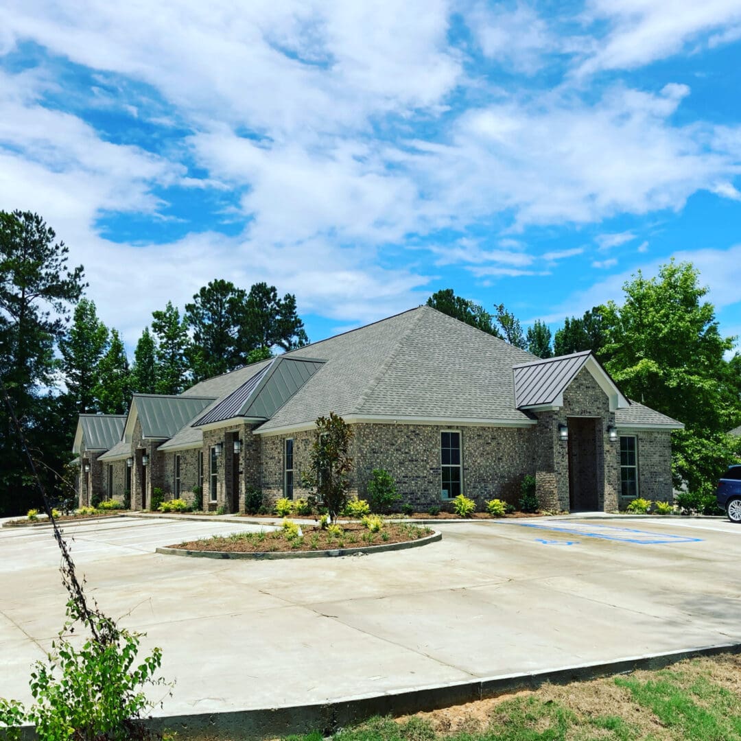 A large building with a circular driveway in front of it.