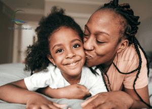 A woman and child are kissing each other.